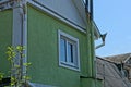 One white window on the green plastered wall of a private house Royalty Free Stock Photo