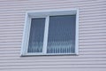 White window on a light pink plastic wall Royalty Free Stock Photo