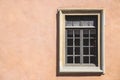 One white window of an orange ancient building. Royalty Free Stock Photo