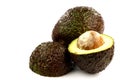 One whole avocado and two halves Royalty Free Stock Photo