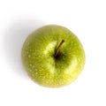 One whole big green apple in water drops on white background isolated close up macro top view Royalty Free Stock Photo