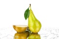 Conference pear with green leaf and one cut pear half on white background isolated close up Royalty Free Stock Photo