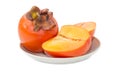 One whole and cut in half of persimmon on saucer Royalty Free Stock Photo