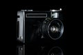 Vintage antique camera isolated on black glass