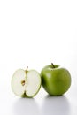 One whole and one half green apples Royalty Free Stock Photo