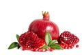One whole and part of a pomegranate with pomegranate seeds Royalty Free Stock Photo