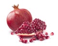 One whole pomegranate and piece on white background