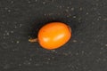 Sea buckthorn berry on grey stone