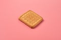 One whole square cookie lies on pink desk on kitchen Royalty Free Stock Photo