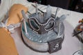 Silver mask cake. The silver mask with feathers on top of the cake . One whole traditional Doberge cake with a mask Royalty Free Stock Photo