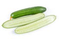 Whole and halves long cucumbers on a white background