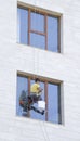 One window washer hanging on rope