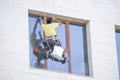 One window washer hanging on rope