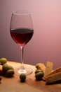 Wineglasses with red wine on wood with cheese and green olives. studio background Royalty Free Stock Photo