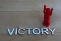 One winner with arms raised next to the word victory Royalty Free Stock Photo