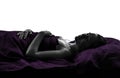 Woman in bed sleeping lying on back silhouette Royalty Free Stock Photo