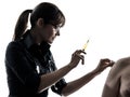 Woman doctor holding surgical needle vaccination silhouette