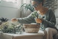 One woman enjoy indoor gardening at home working with plants. Leisure activity at home. Female with eyeglasses work with green Royalty Free Stock Photo