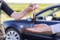 One woman hands over another car key. Rent or purchase of auto. Royalty Free Stock Photo