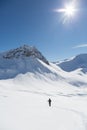 One women snowshoeing towards Valbellhorn mountain in winter landscape Royalty Free Stock Photo