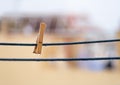 One wooden clothespin on a blue rope with hanging waterdrops after the rain with copy space. Royalty Free Stock Photo