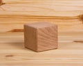 One wooden cube square on wood vintage background copyspace