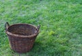 One wooden empty rustic basket on a green field Royalty Free Stock Photo