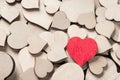 One wooden painted red heart among many colorless wooden hearts Royalty Free Stock Photo