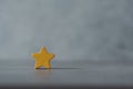 One wooden yellow star shape with an empty spec Royalty Free Stock Photo