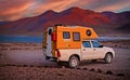 One 4x4 camper truck on lonely camp site at high lake plateau in andes mountains, evening sunset, red mountains - Laguna Miscanti