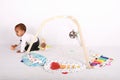 Focused toddler boy playing with Montessori toy for toddlers - baby fehn