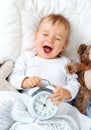 One year old baby with alarm clock Royalty Free Stock Photo