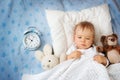 One year old baby with alarm clock Royalty Free Stock Photo