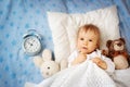 One year old baby with alarm clock Royalty Free Stock Photo