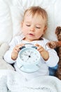 One year old baby with alarm clock Royalty Free Stock Photo