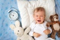 One year old baby with alarm clock Royalty Free Stock Photo
