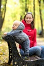 One year old baby boy in autumn park with his mother Royalty Free Stock Photo