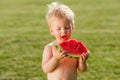 One year old baby boy eating watermelon in the garden Royalty Free Stock Photo