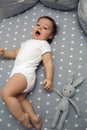 One year old baby boy lying in a round bed Royalty Free Stock Photo