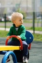 One year old baby boy toddler wearing green sweater at playground Royalty Free Stock Photo