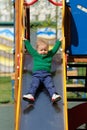 One year old baby boy toddler wearing green sweater at playground Royalty Free Stock Photo