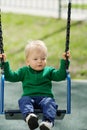 One year old baby boy toddler wearing green sweater at playground Royalty Free Stock Photo