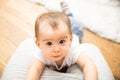 One year old baby claiming on father knees