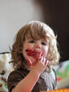 One year old baby girl eating delicious blueberry and black currant pie with her face dirty Royalty Free Stock Photo