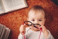 One year old baby with spectackles and books Royalty Free Stock Photo