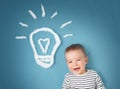 One year old boy and a bulb near. Child with an idea Royalty Free Stock Photo