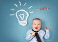 One year old boy and a bulb near. Child with an idea Royalty Free Stock Photo