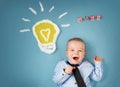 One year old boy and a bulb near. Child with an idea Royalty Free Stock Photo