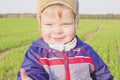 One year old boy farmer going in the field with young wheat. Closeup Royalty Free Stock Photo