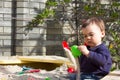 One year old boy take shape of sand in the sandbox in the garden on a sunny spring day Royalty Free Stock Photo